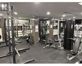 A gym with a variety of equipment including weights and weight machines.