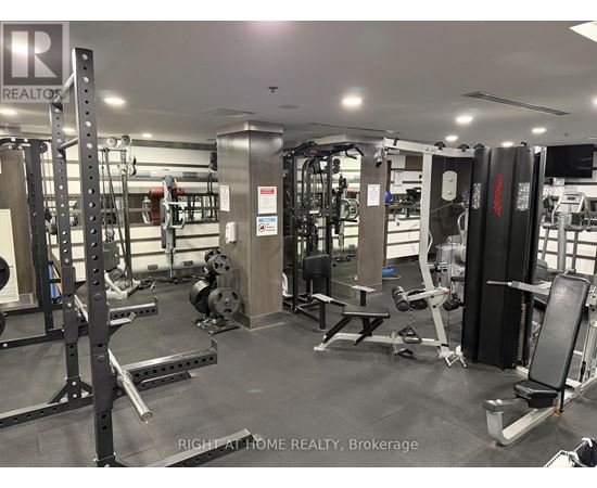 A gym with a variety of equipment including weights and weight machines.