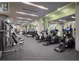 A gym with a variety of equipment including treadmills, stationary bikes, and weight machines.
