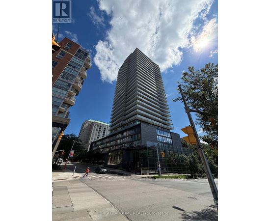 A tall building with many windows is in the center of the image.