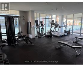A gym with a variety of equipment including treadmills, weights, and exercise machines.