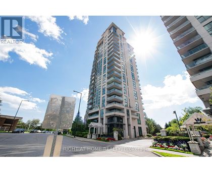 A tall building with a sunny sky in the background.