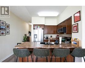 A kitchen with a table and chairs in front of it.