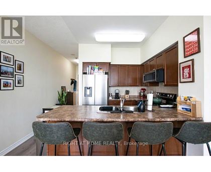 A kitchen with a table and chairs in front of it.