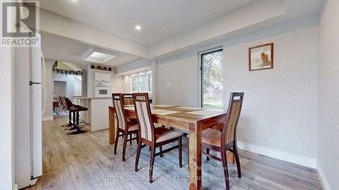 A dining room with a wooden table and chairs.