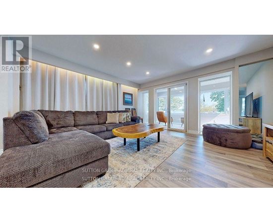 A living room with a grey couch and a wooden coffee table.