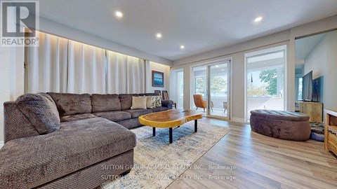 A living room with a grey couch and a wooden coffee table.