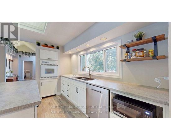 A kitchen with a white oven and white cabinets.