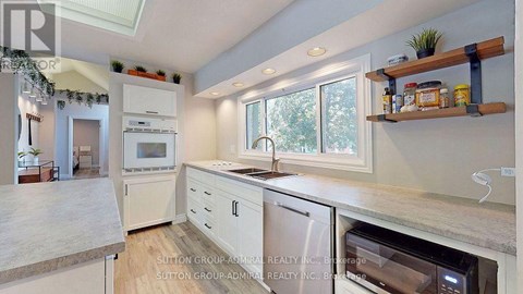 A kitchen with a white oven and white cabinets.