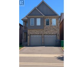A two-story house with a garage and a driveway.