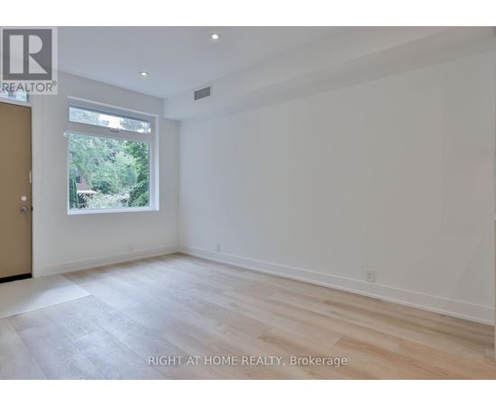 A room with a window and a door, with a sign that says "REALTOR".