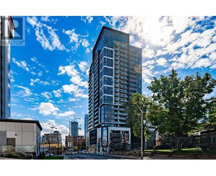 A tall building with many windows is the focal point of the image.