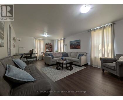 A living room with a grey couch and a coffee table.