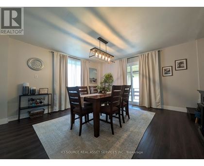 A dining room with a table set for four.