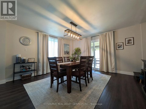A dining room with a table set for four.