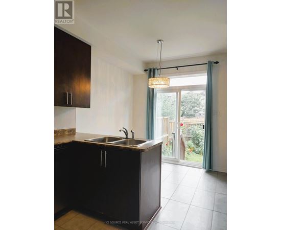 A kitchen with brown cabinets and a sink.