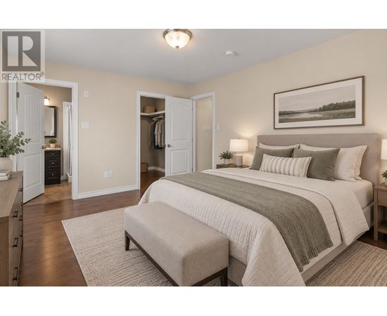 A bedroom with a large bed and a bench in front of it.