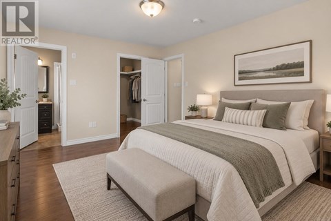 A bedroom with a large bed and a bench in front of it.
