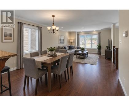 A dining room with a table set for six.