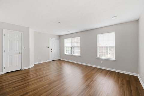 A room with wooden floors and white walls.