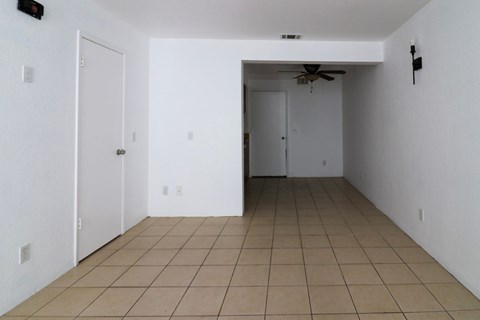 A room with a tiled floor and a ceiling fan.