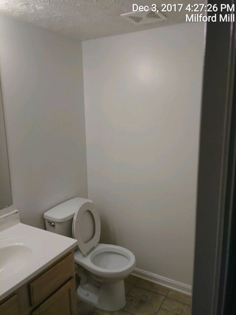 A bathroom with a toilet and sink.