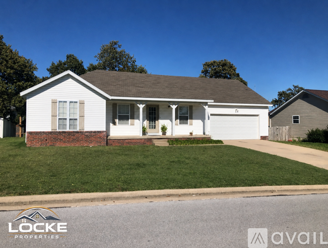 A two-story house with a garage is for sale.