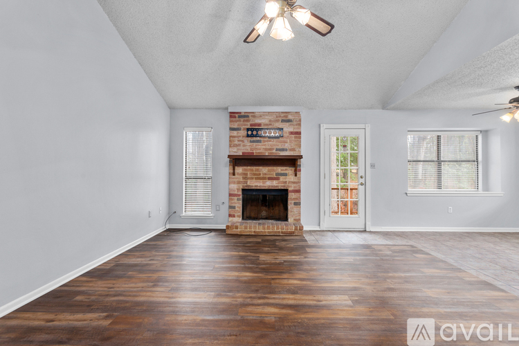 A room with a fireplace and a ceiling fan.