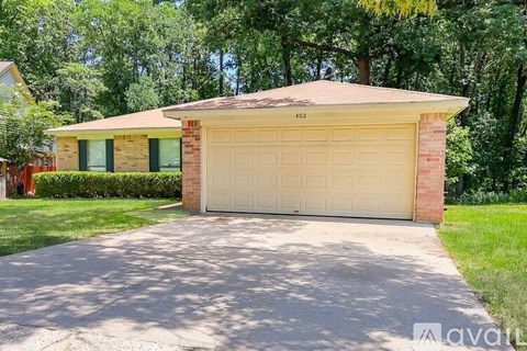 A two-car garage is located in front of a house.