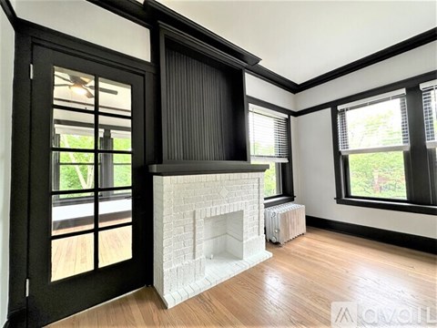 A living room with a fireplace and sliding doors.