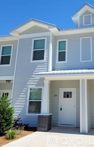 A two-story house with a white door and windows.