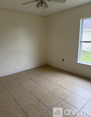 A room with a fan and a window.