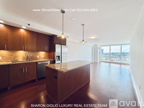 A modern kitchen with wooden cabinets and a large island.