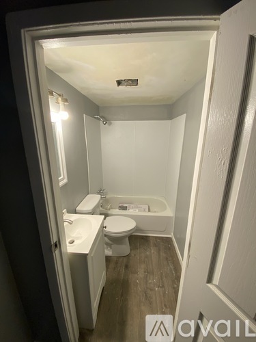A small bathroom with a toilet, sink, and bathtub.