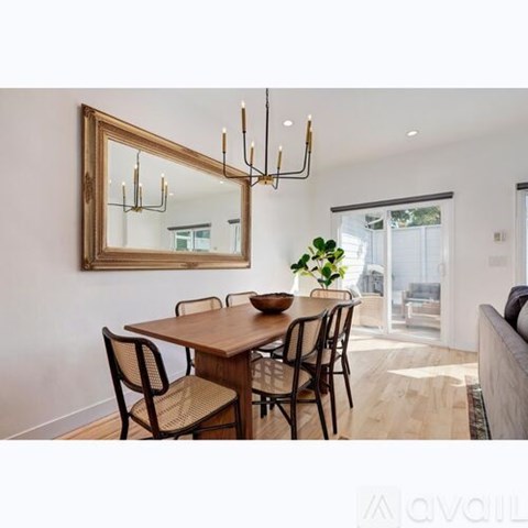 A dining room with a wooden table and chairs.