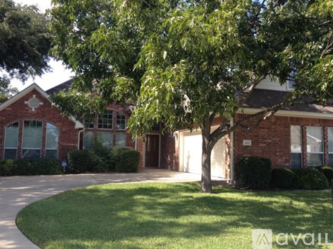 A house with a tree in front of it.