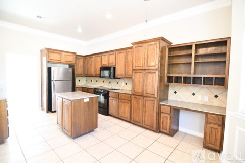 A kitchen with wooden cabinets and appliances.