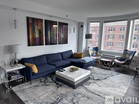 A living room with a blue sofa and a coffee table.