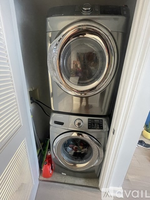 A washing machine is installed in a small space.