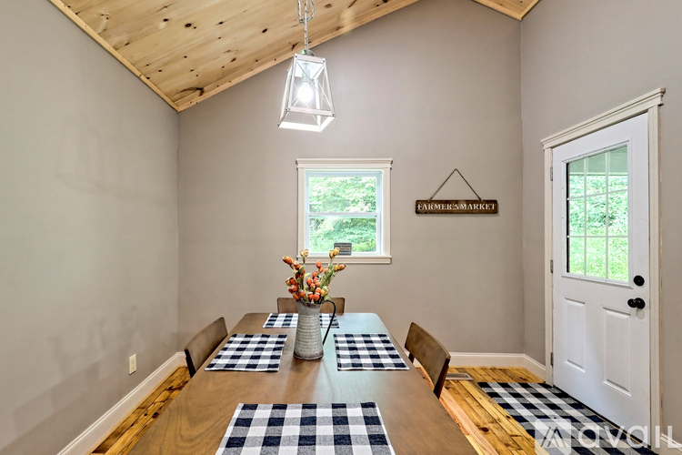 A dining room with a wooden table and chairs.