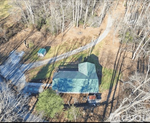 A swimming pool surrounded by trees and a house.
