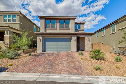 A house with a garage door is for sale.