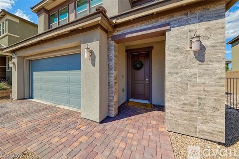 A house with a grey garage door and a brown door.