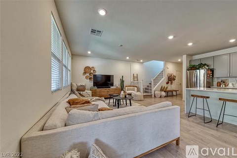 A living room with a grey sofa and a wooden coffee table.