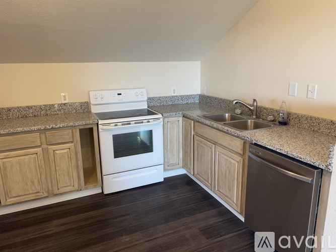 A kitchen with a white oven and sink.