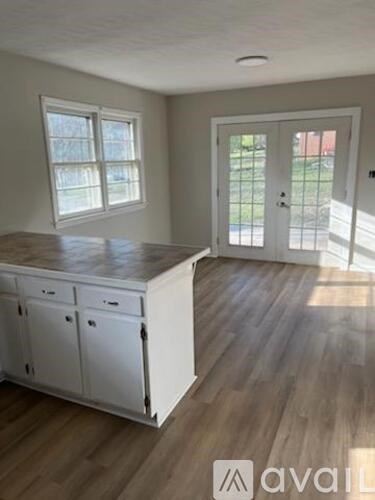 A room with a white cabinet and a door leading outside.