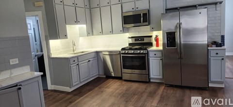 A kitchen with a stainless steel refrigerator and oven.