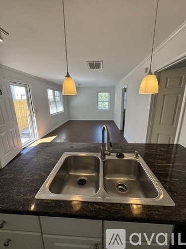 A kitchen with a granite countertop and two sinks.
