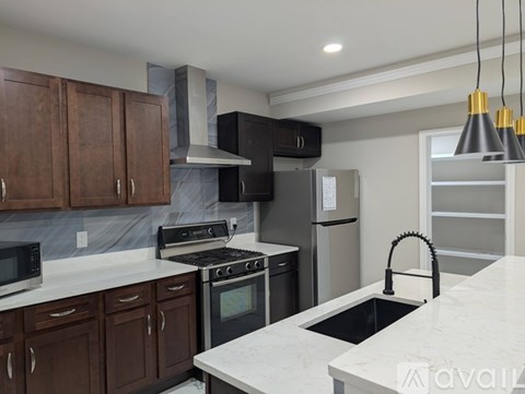 A kitchen with brown cabinets and a white countertop.