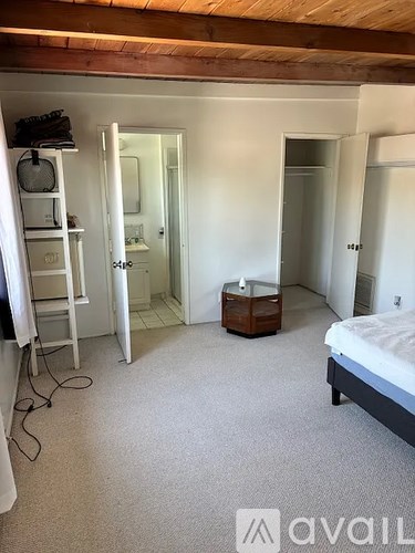 A bedroom with a bed, dresser, and mirror.